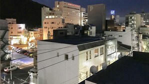 A hotel with multiple floors, a parking area, and satellite dishes. - Guesthouse 017 Reina (Tokushima)