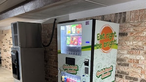 A vending machine with a colorful exterior advertising 'Eat right, be bright!' and 'Quick Break Combo'.