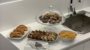 A buffet table with various food items including pastries, cakes, and cereal. - Agorà B&B Urban Relais (Canosa di Puglia)