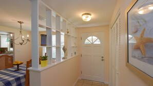 A hallway with a dining area, a white door, and a starfish decoration. - Cozy cottage in Gulf Gate to relax year-round in beautiful Sarasota. (Sarasota)