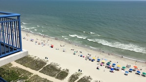 A beach with people, umbrellas, and a railing. - Beautiful Direct Oceanfront 2-BR Condo on Top Floor at Broadwalk, Downtown (Myrtle Beach)