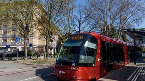 A red tram with the destination sign 'VENEZIA' and the number '06' on its front.