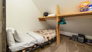 A bunk bed with a fan, a shelf with laundry detergent, and a can of paint on the floor. - Cozy ski-in/ski-out home w/fireplace & clawfoot tub - Little Plume Flat (Big Sky)