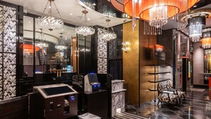 A hotel lobby with a reception desk, a self-service kiosk, a marble-tiled floor, and a chandelier. - APA Hotel Ueno Inaricho Ekikita (Tokyo)