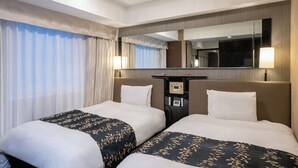 A hotel room with two beds, a large mirror, a desk with a control panel, and a view of the outdoors. - APA Hotel Ueno Inaricho Ekikita (Tokyo)