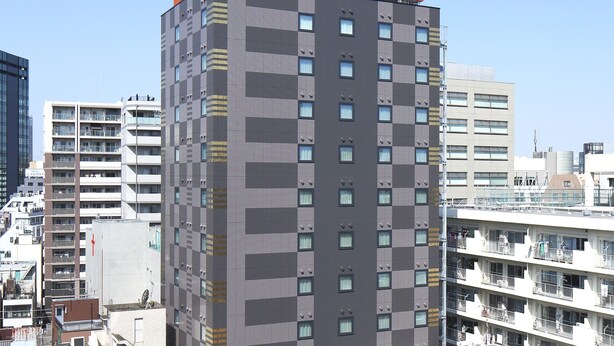 A multi-story building with "APA HOTEL" signage at the top. - APA Hotel Ueno Inaricho Ekikita (Tokyo)