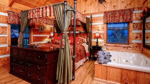 A four-poster bed with a canopy, a wooden dresser, a large window with blinds, and a bathtub. - OPEN 10/25-30, 11/8-11, 14-25 Knight of My Dreams,Secluded,Amazing View, 1 level (Sevierville)