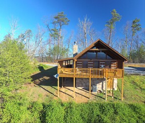 A wooden cabin with a stone foundation, a balcony, and a chimney. - Avail 10/2-6, 25-30, 11/8-30 Knight of My Dreams, Secluded, Amazing View,1 level (Sevierville)
