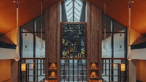 A spacious lobby with a high ceiling, large windows, and a central stained glass feature. - The Key Highland Nasu (Nasu)