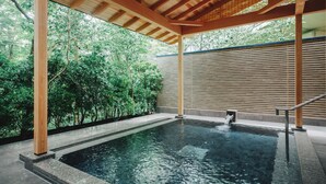 A serene indoor swimming pool with a wooden pergola overhead, surrounded by lush greenery. - The Key Highland Nasu (Nasu)