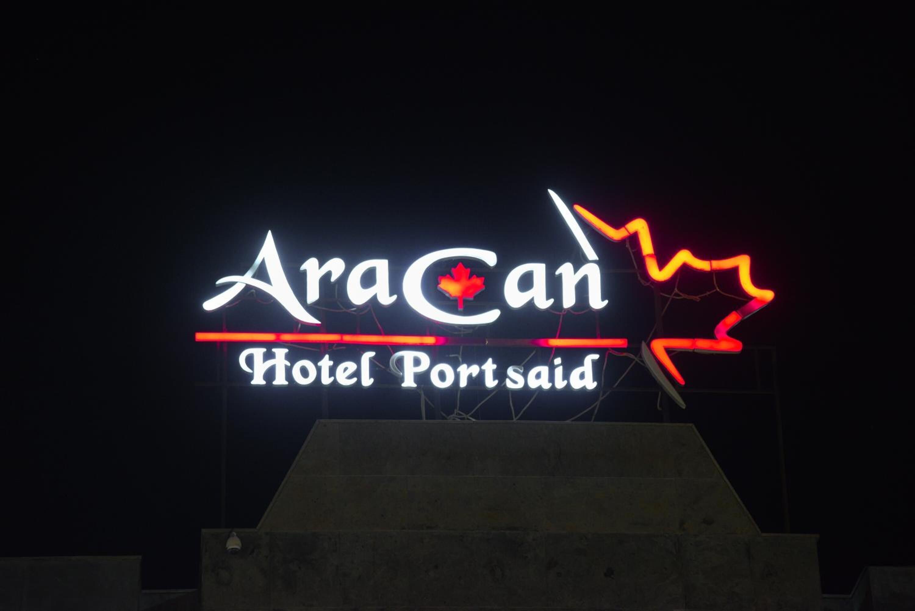 A neon sign for AraCan Hotel Portsaid.