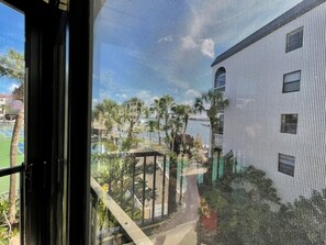 Guests can enjoy a serene view of lush greenery and palm trees from the comfort of their room.