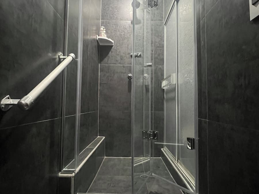 Economy eenpersoonskamer | Badkamer | Een douche, een regendouche, gratis toiletartikelen, een haardroger