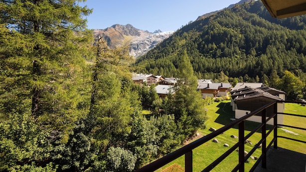 A mountain view with a chalet-style building surrounded by dense forest and snow-capped peaks. - Bel'Alp 16 Historical Residence Near Ski Lifts at Le Tour in Chamonix, Le Tour (Argentière), France (Le Tour (Argentière))