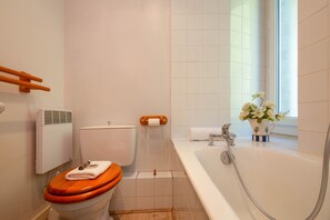 A bathroom with a toilet, a bathtub, and a window. - Bel'Alp 16 Historical Residence Near Ski Lifts at Le Tour in Chamonix, Le Tour (Argentière), France (Le Tour (Argentière))