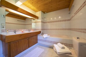 A bathroom with a wooden vanity, a bathtub, and a shower. - Chalet du Golf618 Family retreat for 9 next to Ski lifts, Chamonix, France (Chamonix)