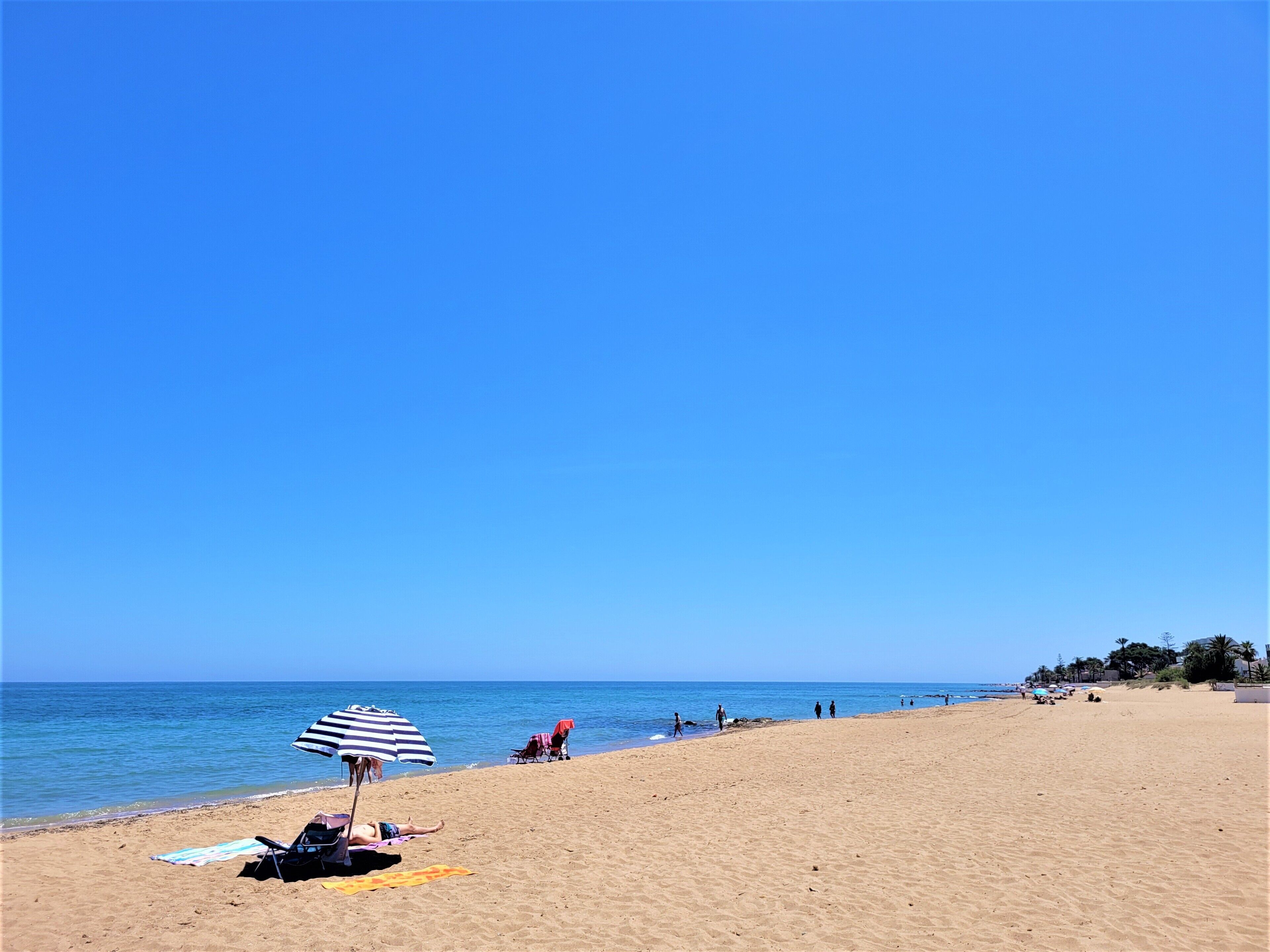 On the beach, sun-loungers