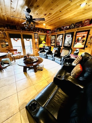 A cozy living room with a fireplace, leather sofas, and a coffee table.