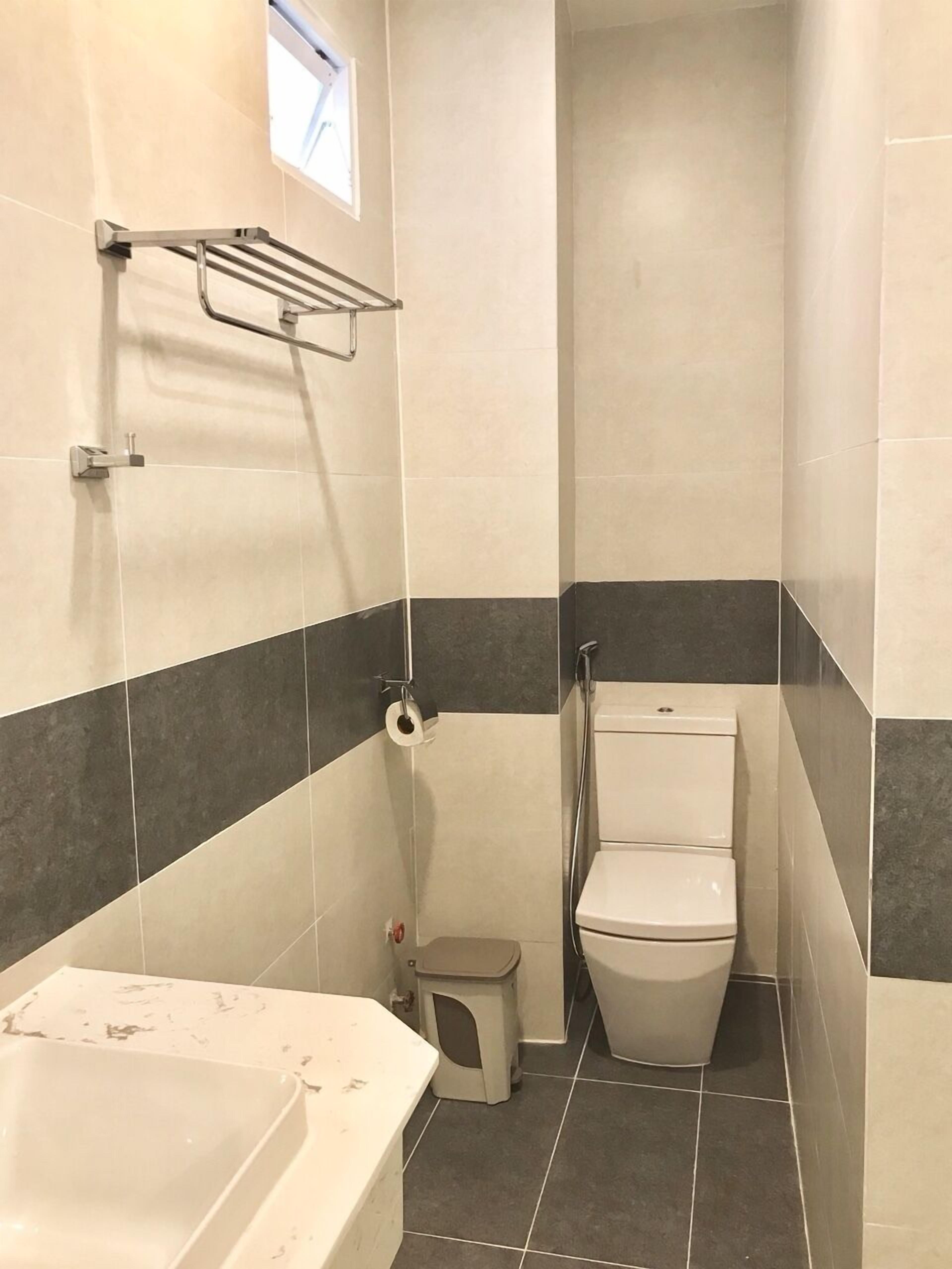 A small bathroom with a bathtub, toilet, and shower.