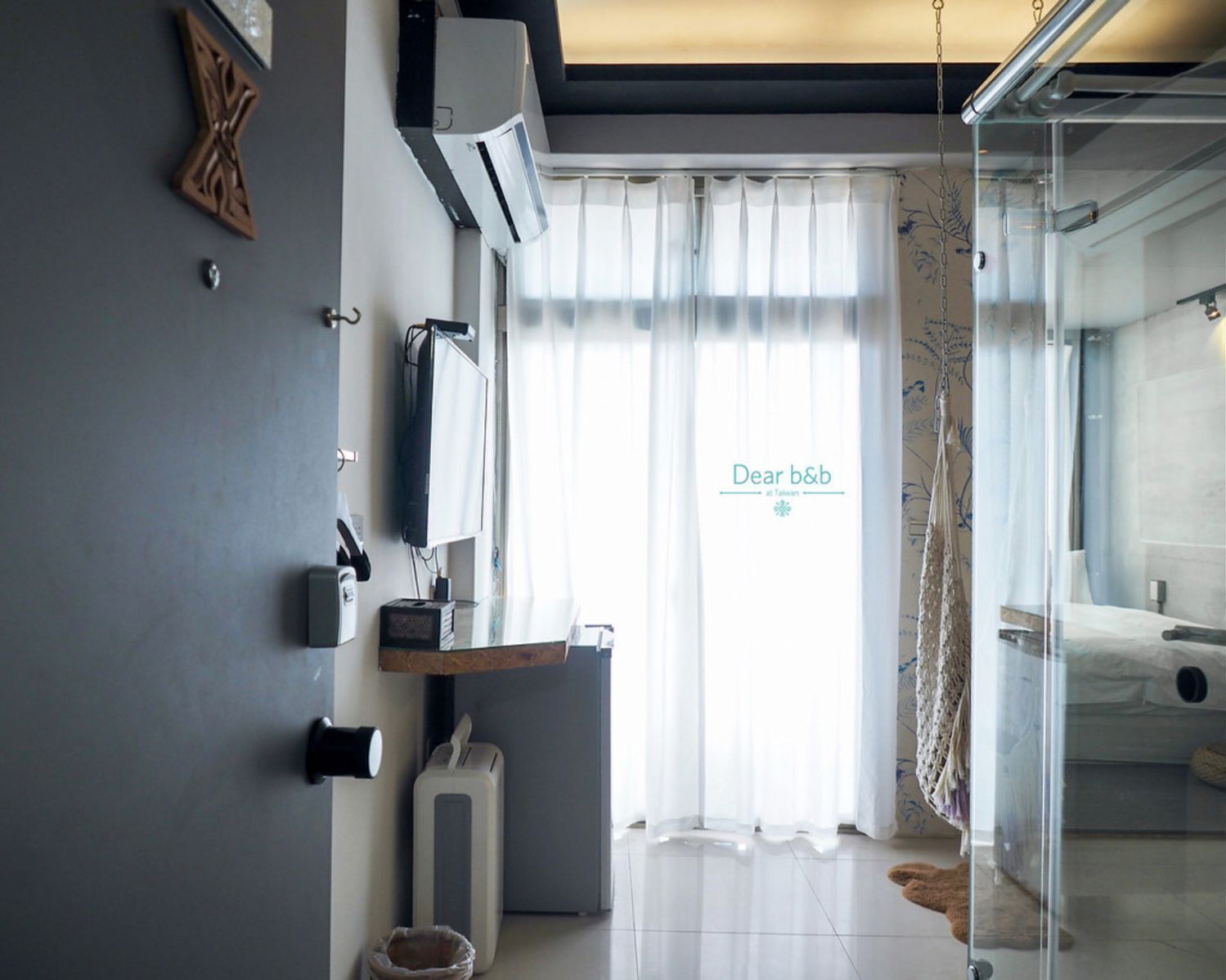 A modern bathroom with a glass shower enclosure, a toilet, and a sink area.
