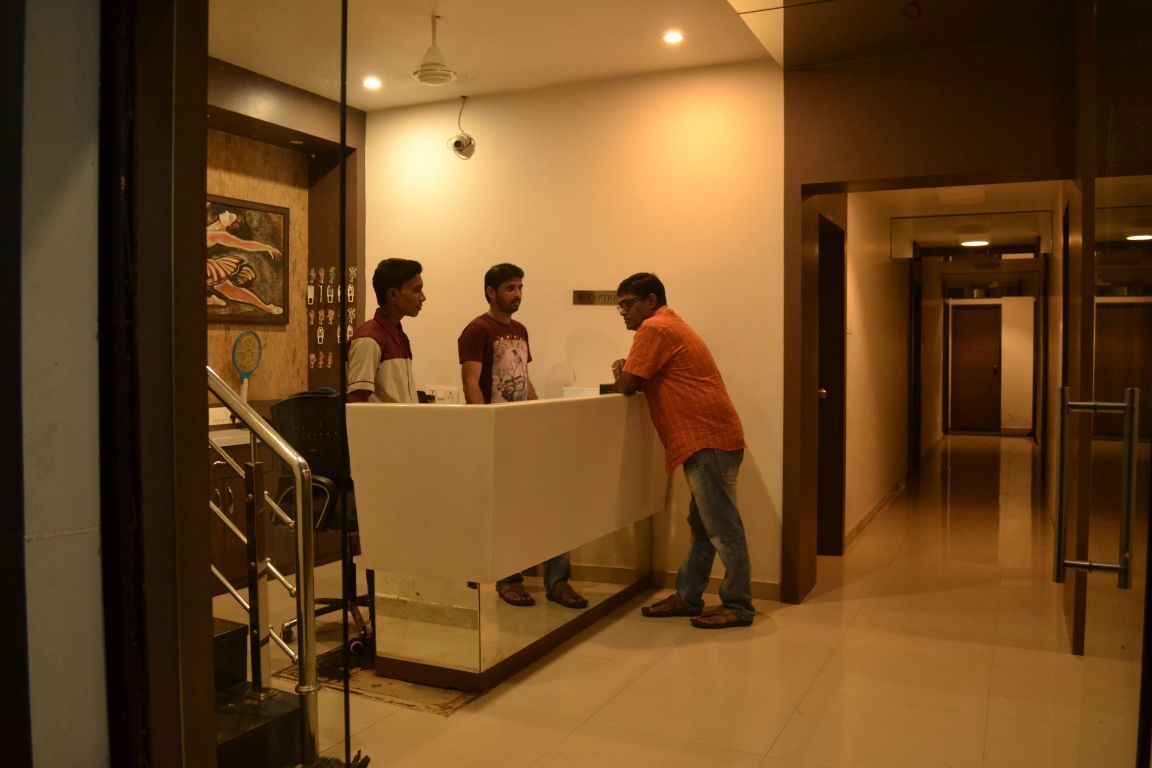 A reception area with a counter, a staircase, and an elevator.