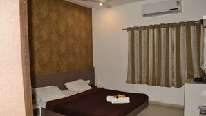 Une chambre d’hôtel équipée d’un lit, d’un bureau et d’un appareil de climatisation.