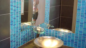 A bathroom with a sink, mirror, and blue-tiled walls. - Modern, Family Friendly & Peaceful Villa with 15m long Infinite Private Pool & J (Theologos, Malesina)