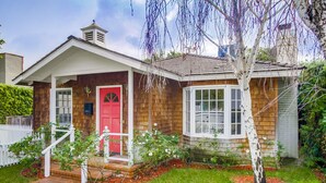 A two-story house with a red front door, white trim, and a small porch. - A Touch of Cape Cod in West Hollywood (West Hollywood)