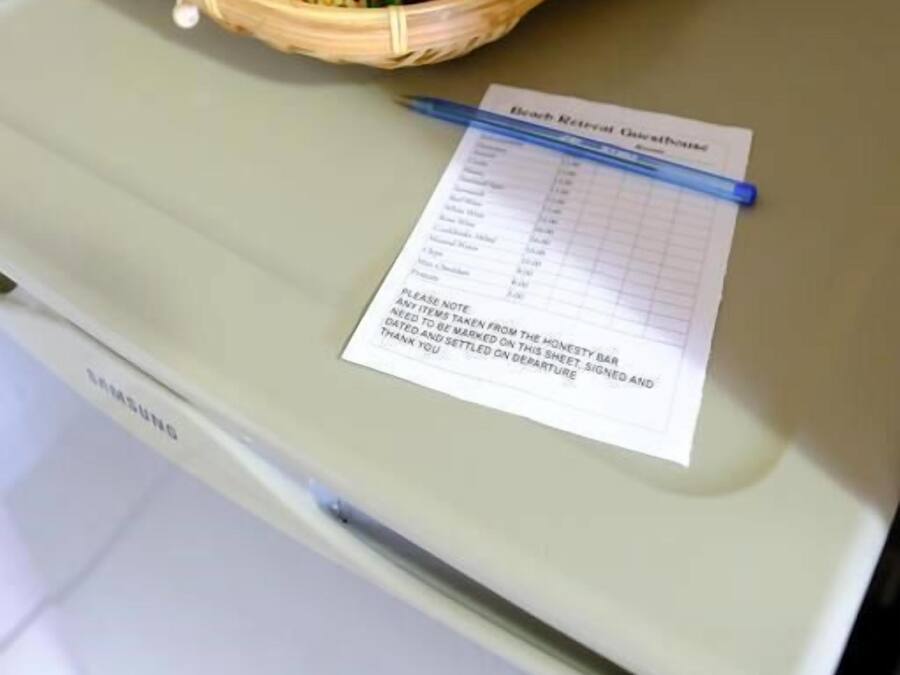 Un refrigerador Samsung con una cesta de bocadillos y un letrero de casa de huéspedes.
