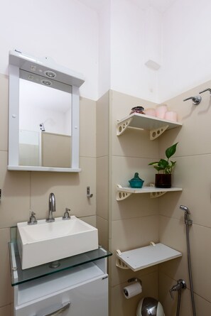 A bathroom with a white sink, mirror, and glass shelves. - Omar do Rio - HG904 (Rio de Janeiro)