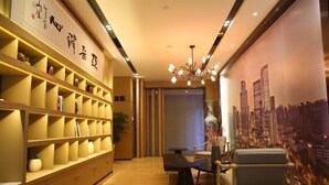 A modern hotel lobby with wooden shelving, a black table, and a cityscape mural. - Atour Hotel Wuhou Temple Chengdu (Chengdu)
