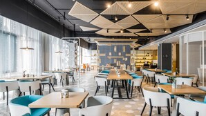 A modern dining area with hexagonal patterned flooring, wooden tables, and chairs with teal cushions. - Atour Hotel Wuhou Temple Chengdu (Chengdu)