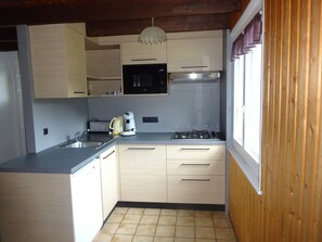 A compact kitchen with a gas stove, a coffee maker, and a microwave. - Mountain chalet in La Bresse Htes Vosges label "Family Plus", Gîte de France (La Bresse)