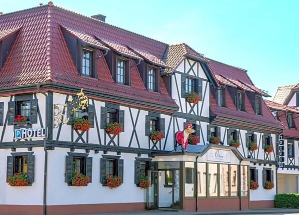 A traditional half-timbered building with a sign indicating it's a hotel.