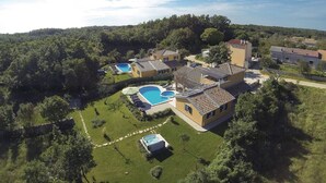 A residential area with multiple houses, a swimming pool, and a hot tub.