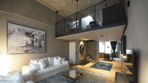 A modern living room with a white sofa, a coffee table, and a large painting on the wall. - Edit Lofts  (Turin)