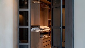A walk-in closet with open doors, shelves, and hanging space. - Edit Lofts  (Turin)