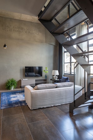 Deluxe Loft | Living area | 43-inch flat-screen TV with digital channels