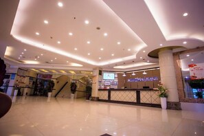 A spacious lobby with a reception desk, a staircase, and a digital clock. - Crowne International Business Hotel (Shiyan)