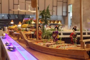 A sushi bar with a traditional wooden boat display and a decorative backdrop. - Sanhe Grand New Century Hotel Pingyang (Pingyang)