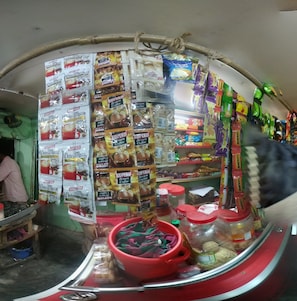 A small shop with shelves stocked with coffee and snacks. - Tahabi Shoe Store (Wazirpur)