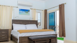 A bedroom with a bed, bedside tables, a bench, a window with curtains, and a painting on the wall. - Tropical Luxury Dreams Ocho Rios (Ocho Rios)