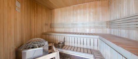 A sauna with wooden walls and benches.