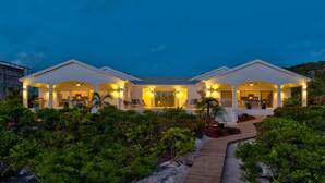 A modern two-story house with a covered patio, a swimming pool, and a well-maintained garden. - Coconut Beach Villa! BEACHFRONT Sapodilla! Private Pool! Luxury Family Friendly! (Providenciales)