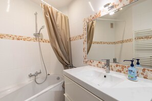 Bathtub, hair dryer, towels, soap