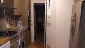 A kitchen with granite countertops, stainless steel appliances, and wooden cabinets. - Los Corzos Burgohondo Avila (Burgohondo)