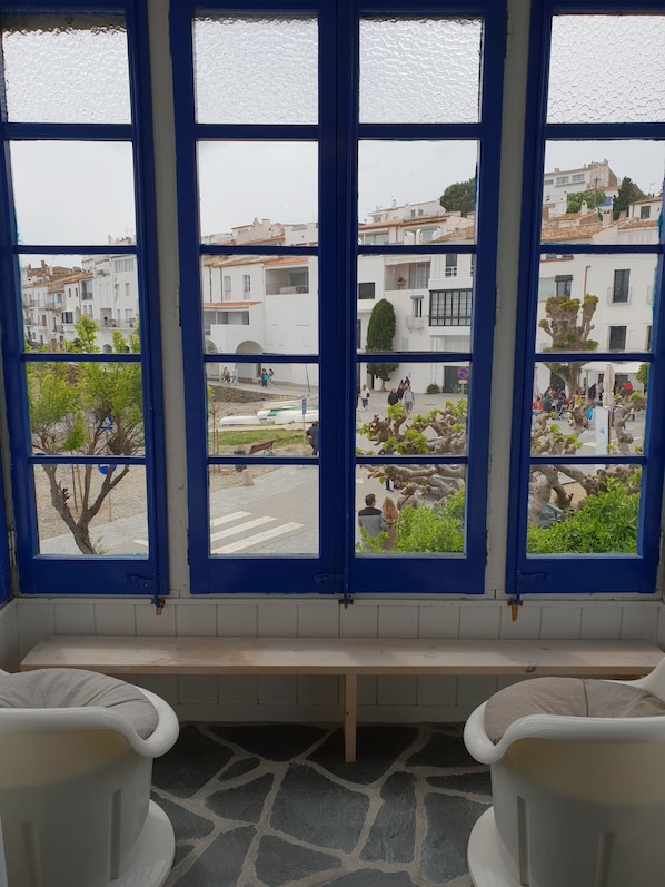 A room with a bench and a view through large windows.