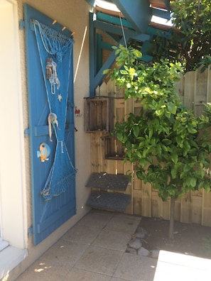 outdoor space with bird feeders and a secure entrance.
