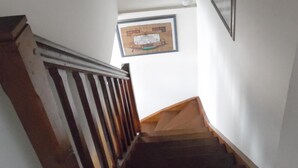 A staircase with wooden railings and a handrail, leading up to a landing with framed artwork on the walls. - GITE F2 60 M2 WITH TERRACE ON PORT CLASSIFICATION PREFECTORAL 2 STARS        (Saint-Valery-En-Caux)