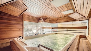 A wooden interior with a hot tub, a staircase, and a view of the outdoors. - Remodeled unit & mountain view in the ♥ of Central Village, walk to the lifts!  (Frisco)